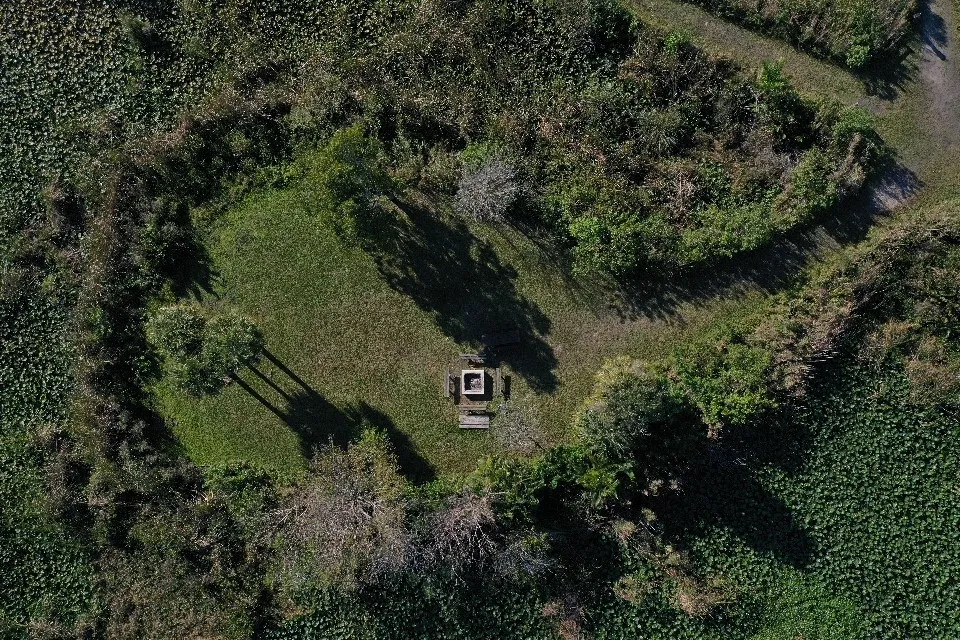 DJI_0022.DNG a sign on the side of a lush green field