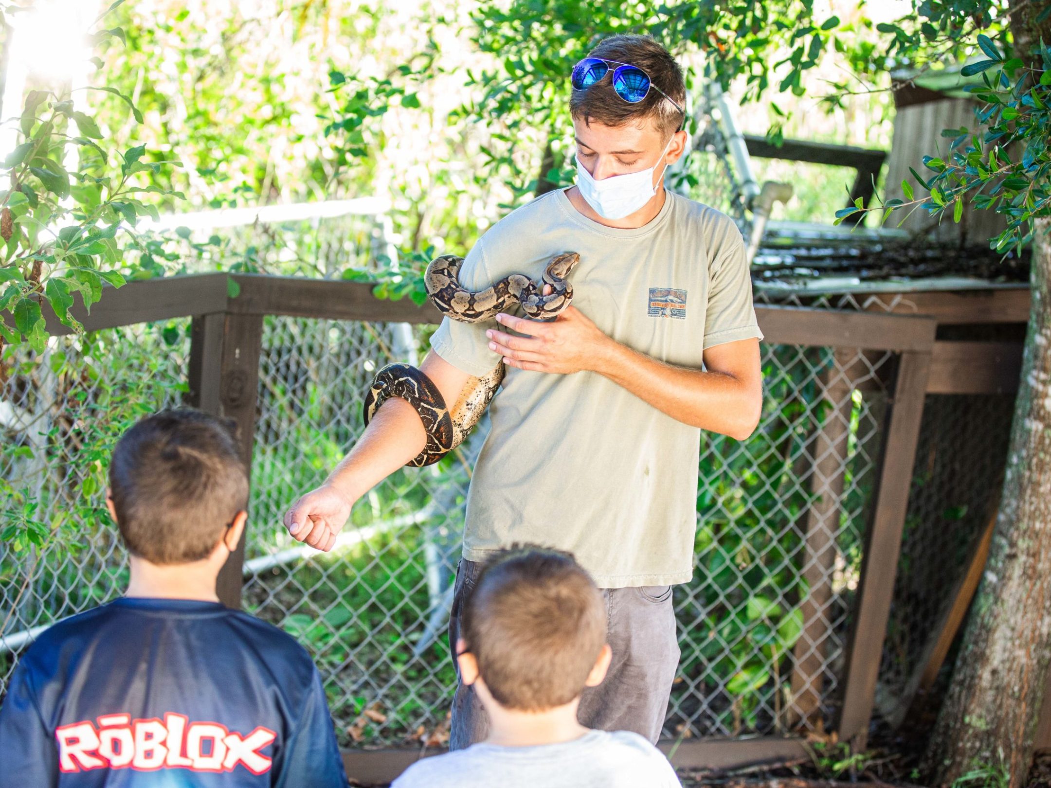 a man standing in front of a fence