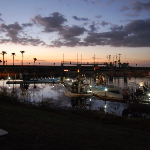a large body of water with a city in the dark