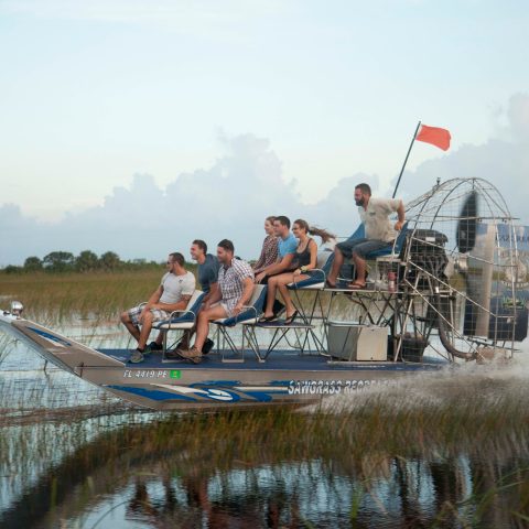 a group of people riding on the back of a boat