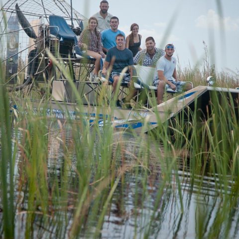 a group of people standing next to a body of water