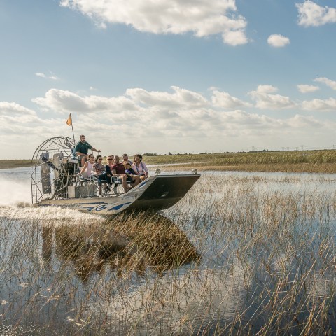a man flying through the air over a body of water