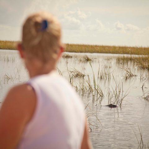 a man standing next to a body of water