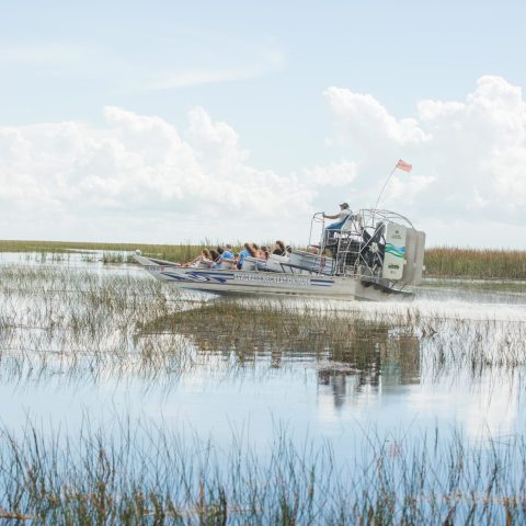 a man standing next to a body of water