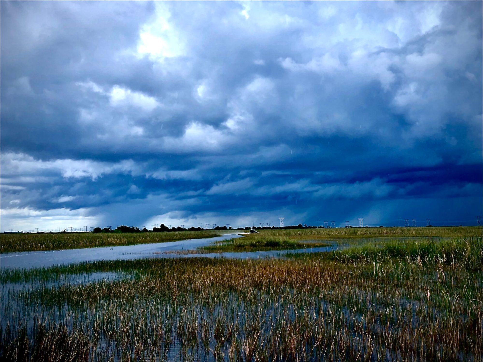 a group of clouds in the sky over a body of water